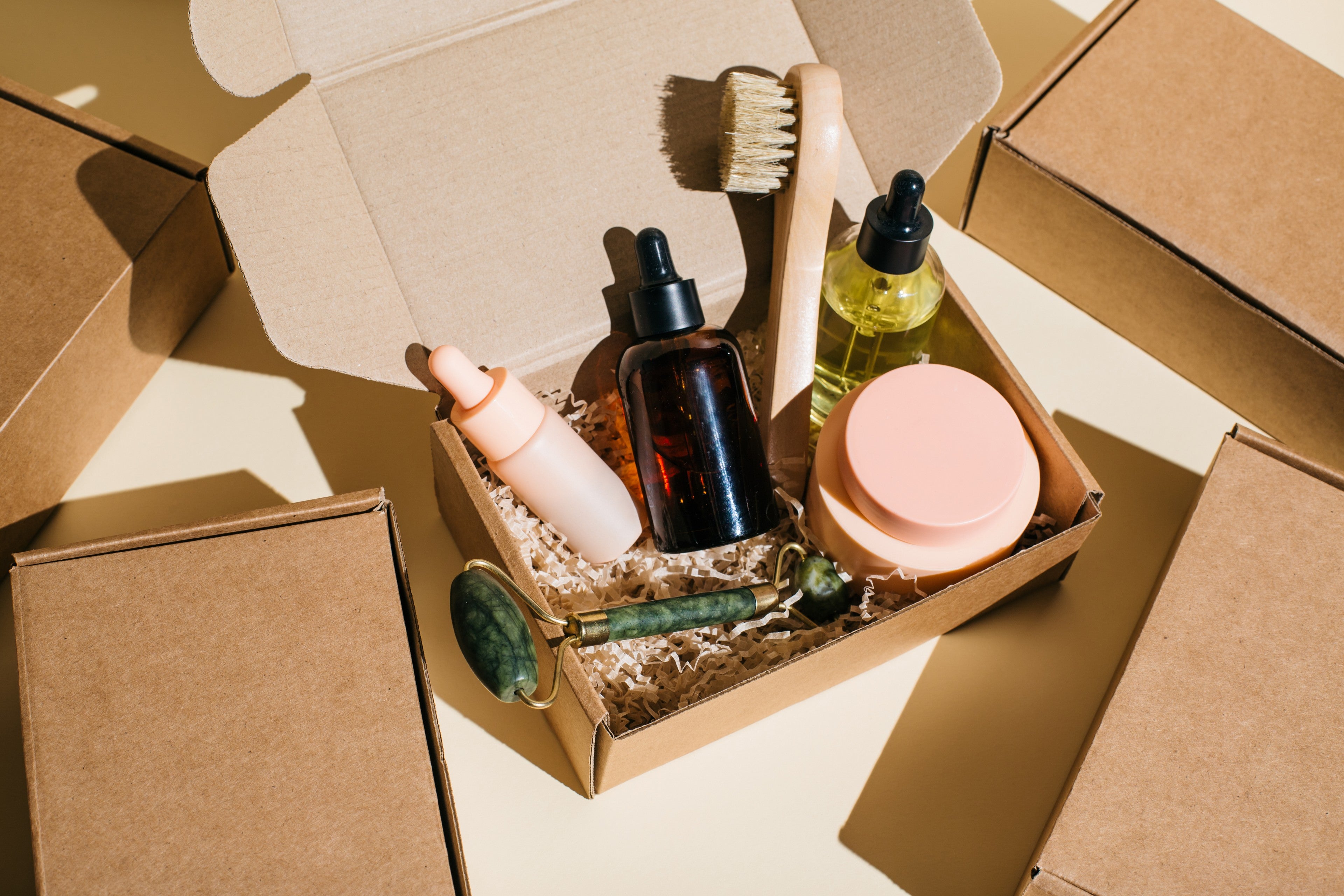 Beauty box with face and body care products on beige background