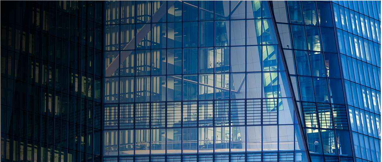 Zoomed in picture of the side of a glass office building