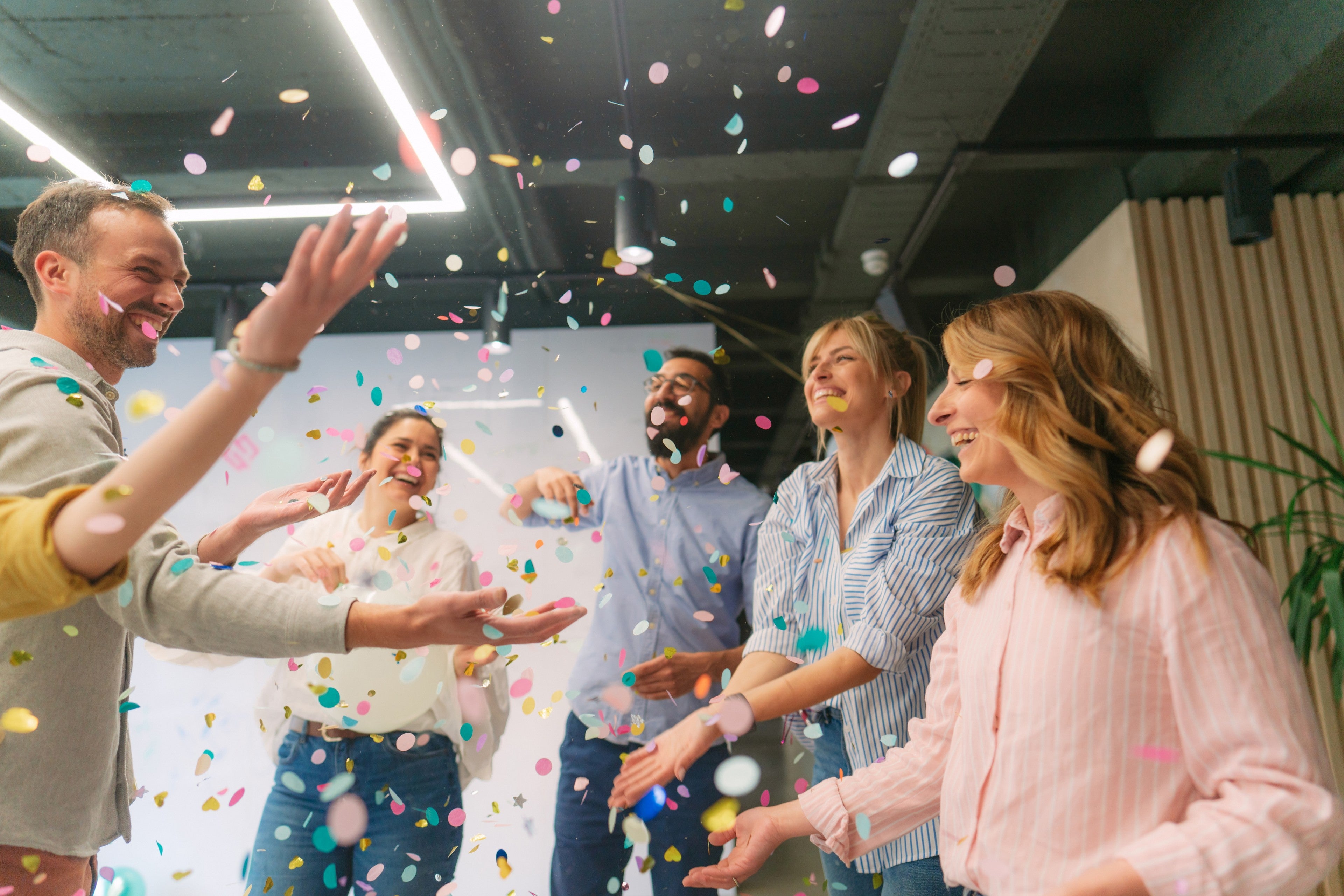 Group of coworkers having a happy occasion and celebrating together in their workplace