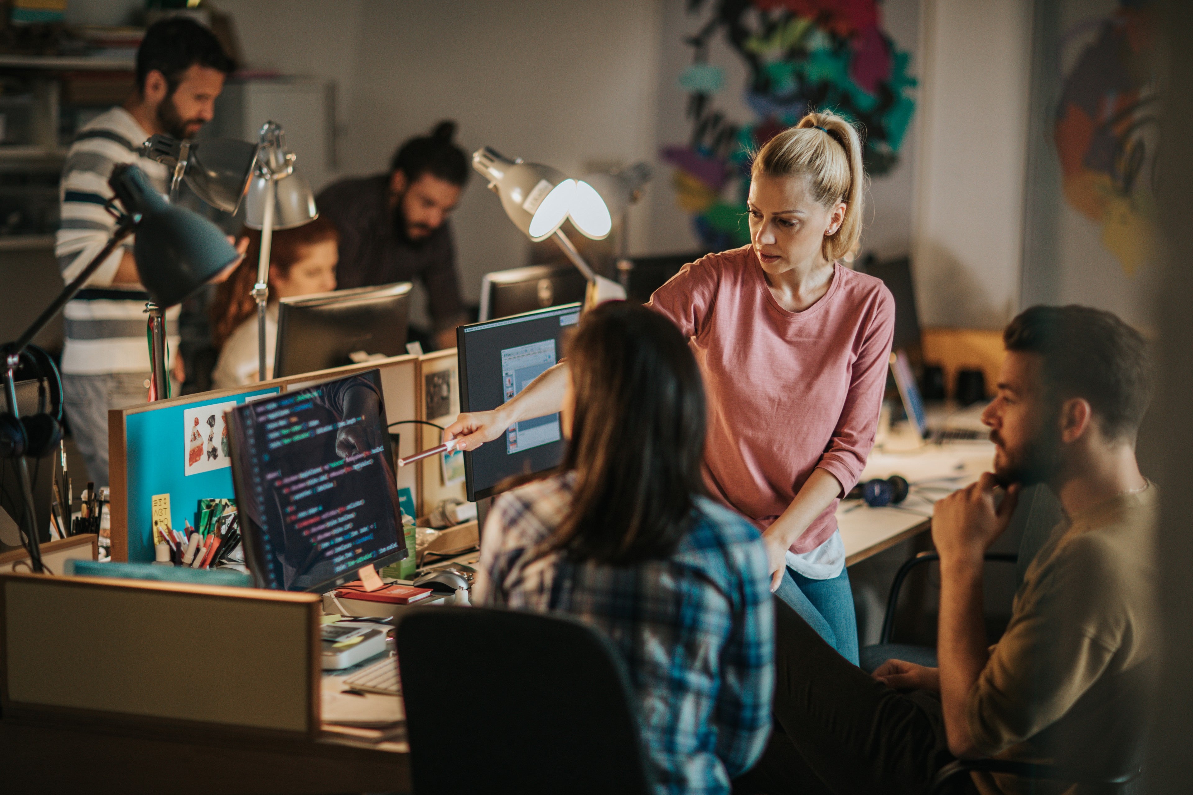 Team of young computer programmers working in the office