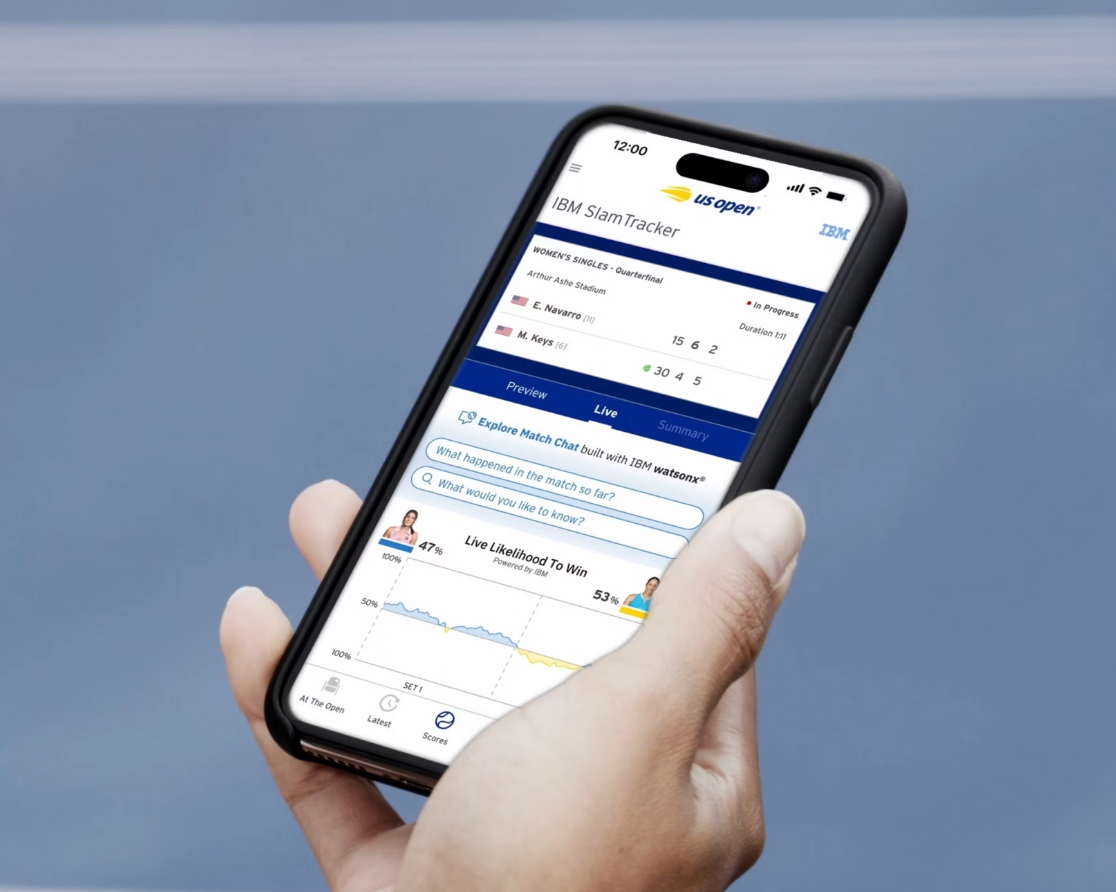 Close up picture of a person's hand holding an iphone with the us open app showing statistics